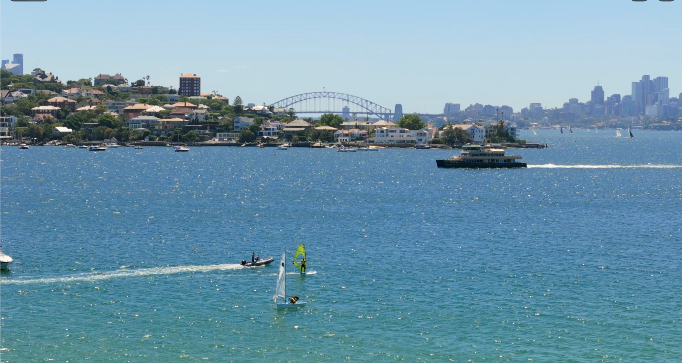 Sydney Harbour Bridge view from Villa Biscaya with sailboats, windsurfer and ferry