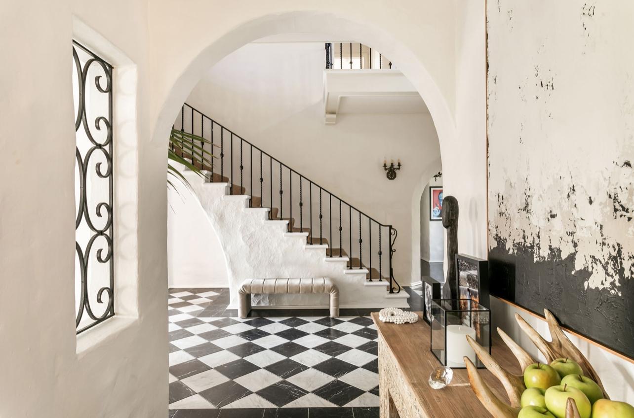 Villa Biscaya curved white staircase with wrought iron railing