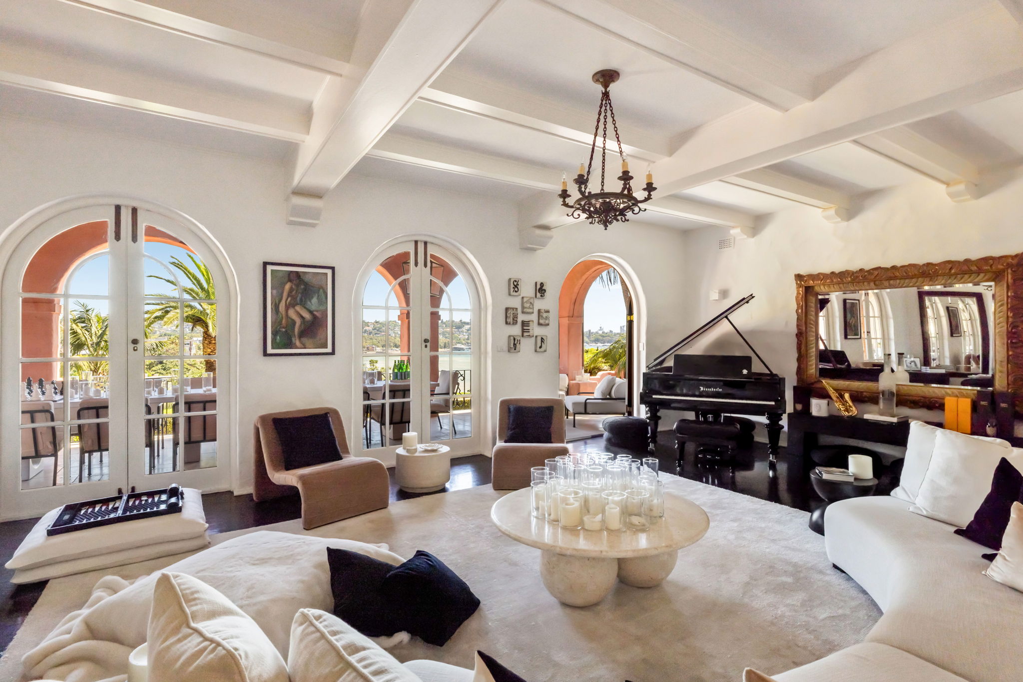 Villa Biscaya living room with grand piano, coffered ceiling and arched French doors