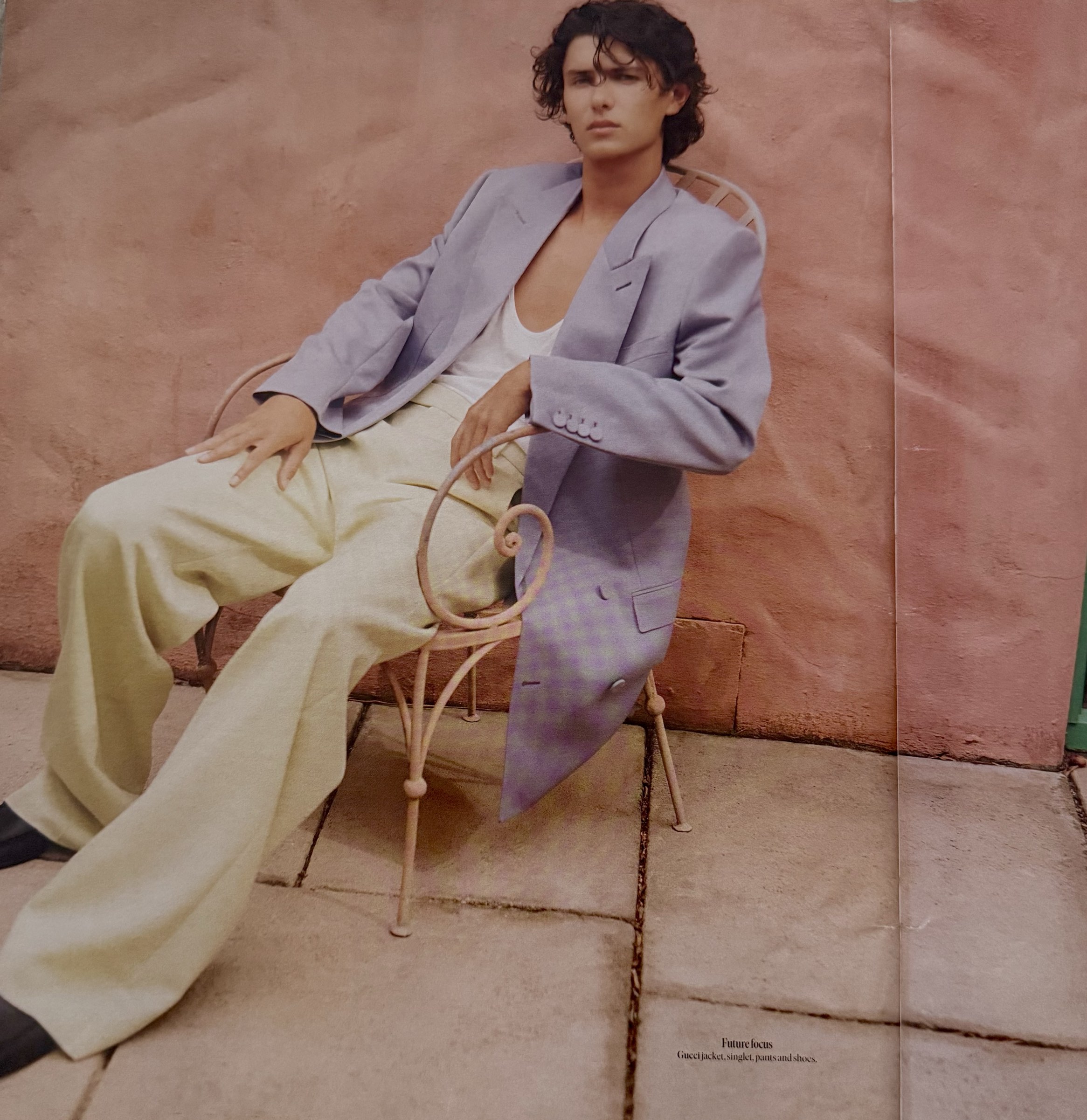 Count Nikolai in lavender Gucci blazer on pink terrace with bistro chair